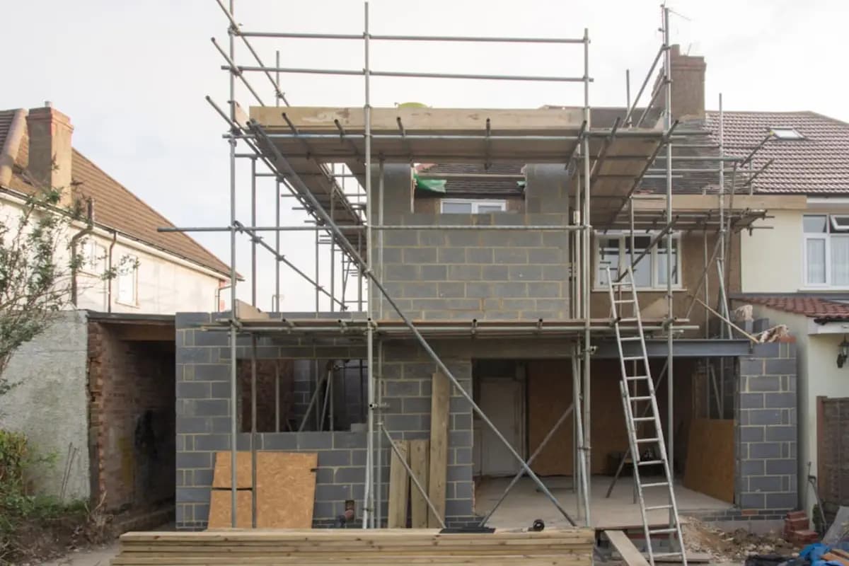 A London house with scaffolding up and a blockwork extension going in